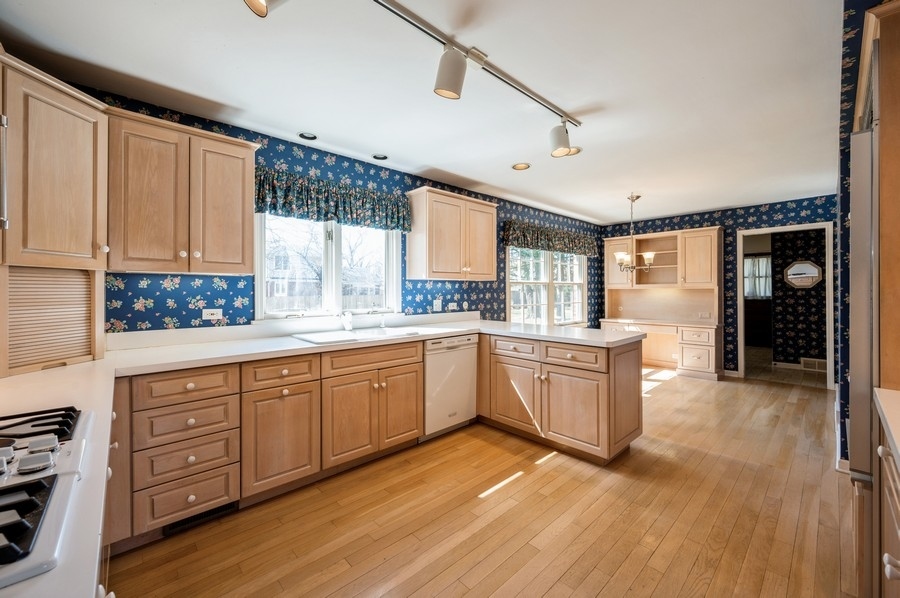 2961 Cherry Lane Northbrook, IL 60062 - Photo 5 of 21 a large kitchen with cabinets wooden floor and stainless steel appliances