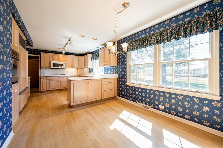 2961 Cherry Lane Northbrook, IL 60062 - Photo 6 of 21 a large kitchen with kitchen island a large window a sink and stainless steel appliances