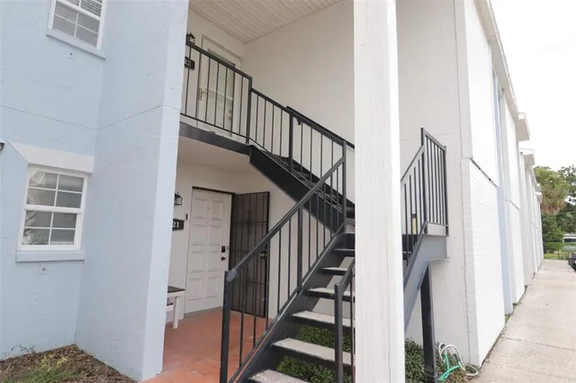 a view of staircase with wooden floor and a window