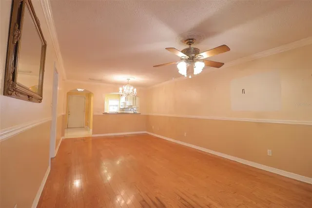 a view of an empty room with a ceiling fan