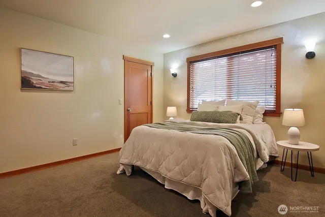 a bed sitting in a bedroom next to a window