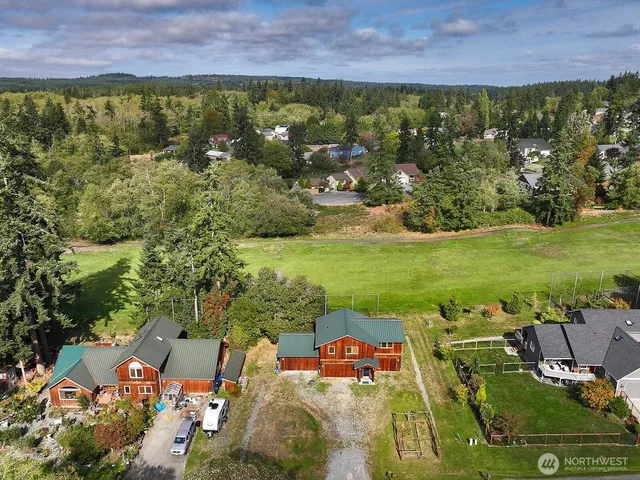 an aerial view of residential houses with outdoor space and swimming pool