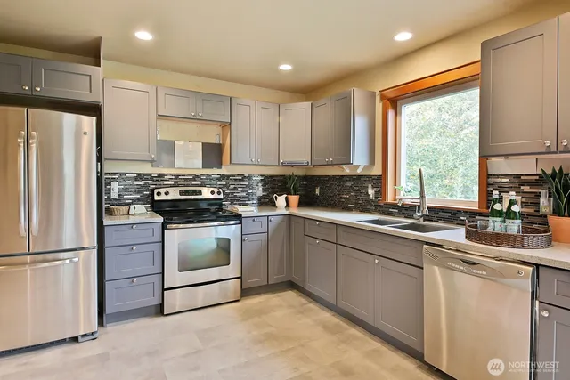 a kitchen with appliances cabinets and a sink
