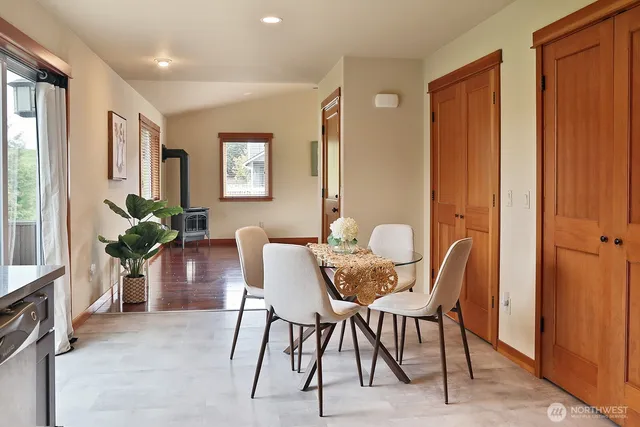 a view of a dining room with furniture and a potted plant