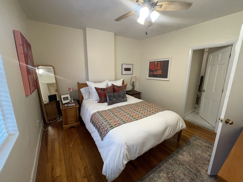 9 Primus Avenue, Unit 1 Boston, MA 02114 - Photo 14 of 19 a bedroom with wooden floor and furniture