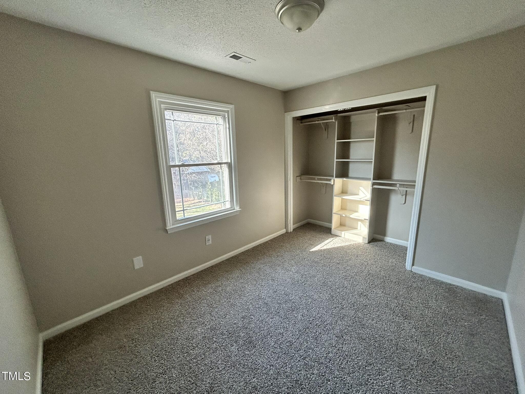 13535 Cleveland Road Garner, NC 27529 - Photo 11 of 18 an empty room with windows and closet