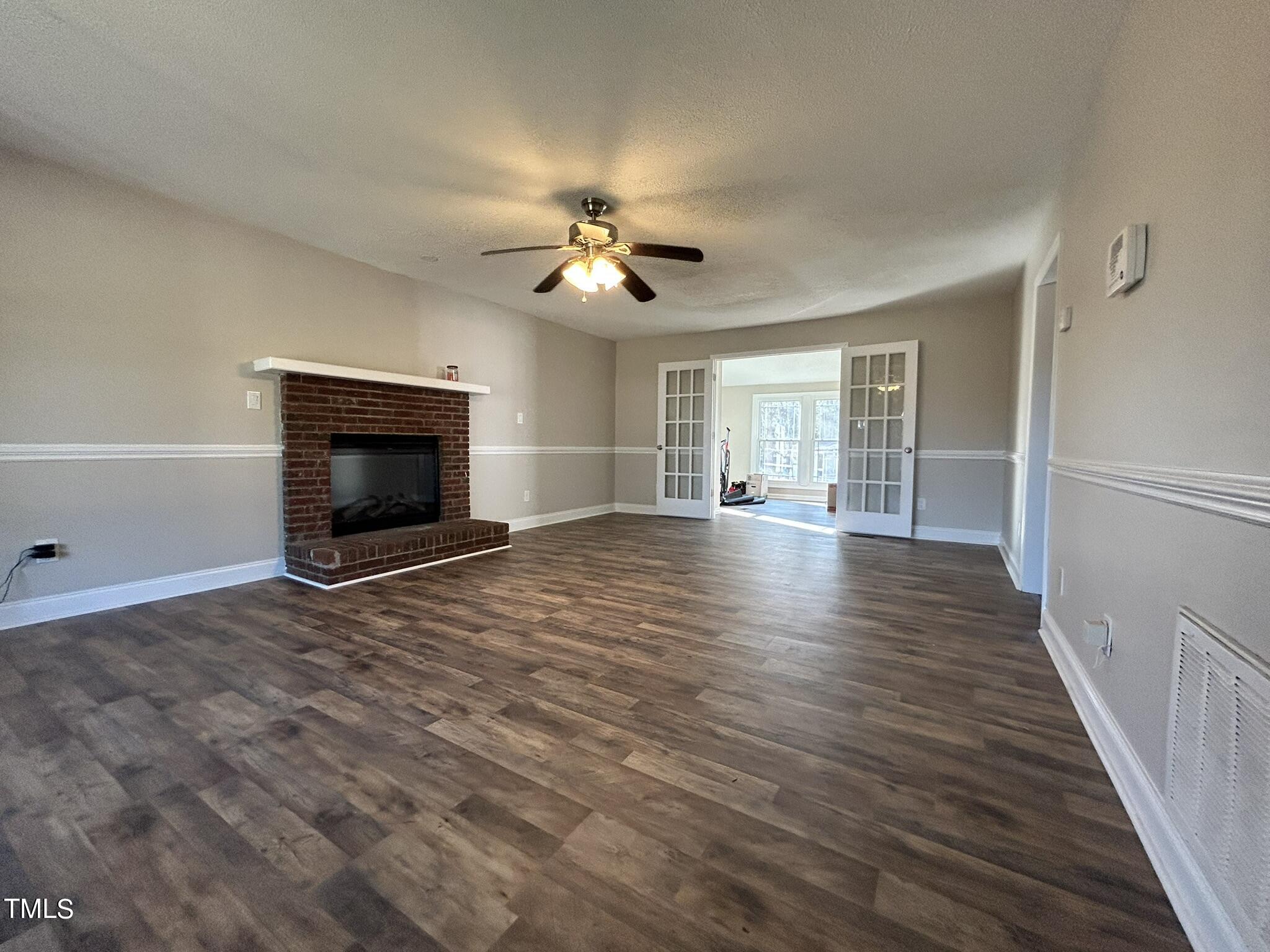 13535 Cleveland Road Garner, NC 27529 - Photo 4 of 18 a view of empty room with wooden floor and fan