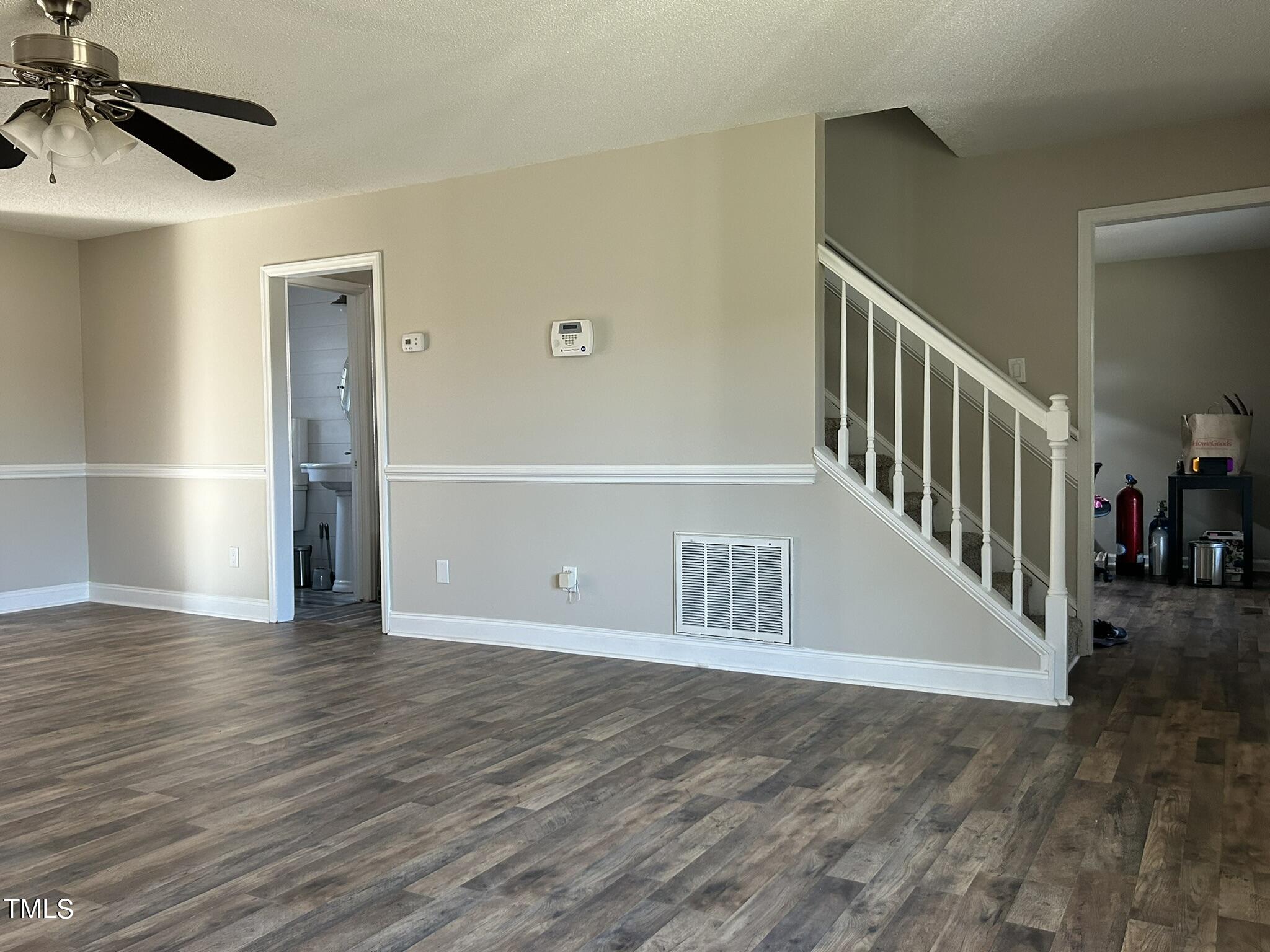 13535 Cleveland Road Garner, NC 27529 - Photo 5 of 18 a view of an empty room with wooden floor and a cabinet