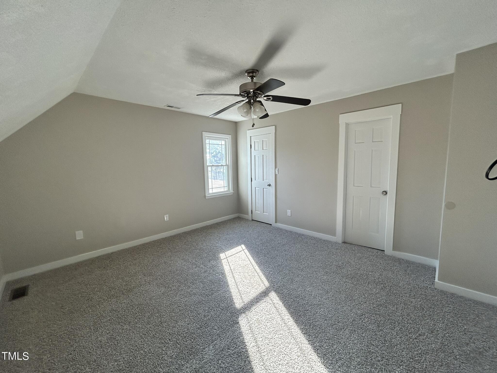 13535 Cleveland Road Garner, NC 27529 - Photo 9 of 18 an empty room with windows and fan