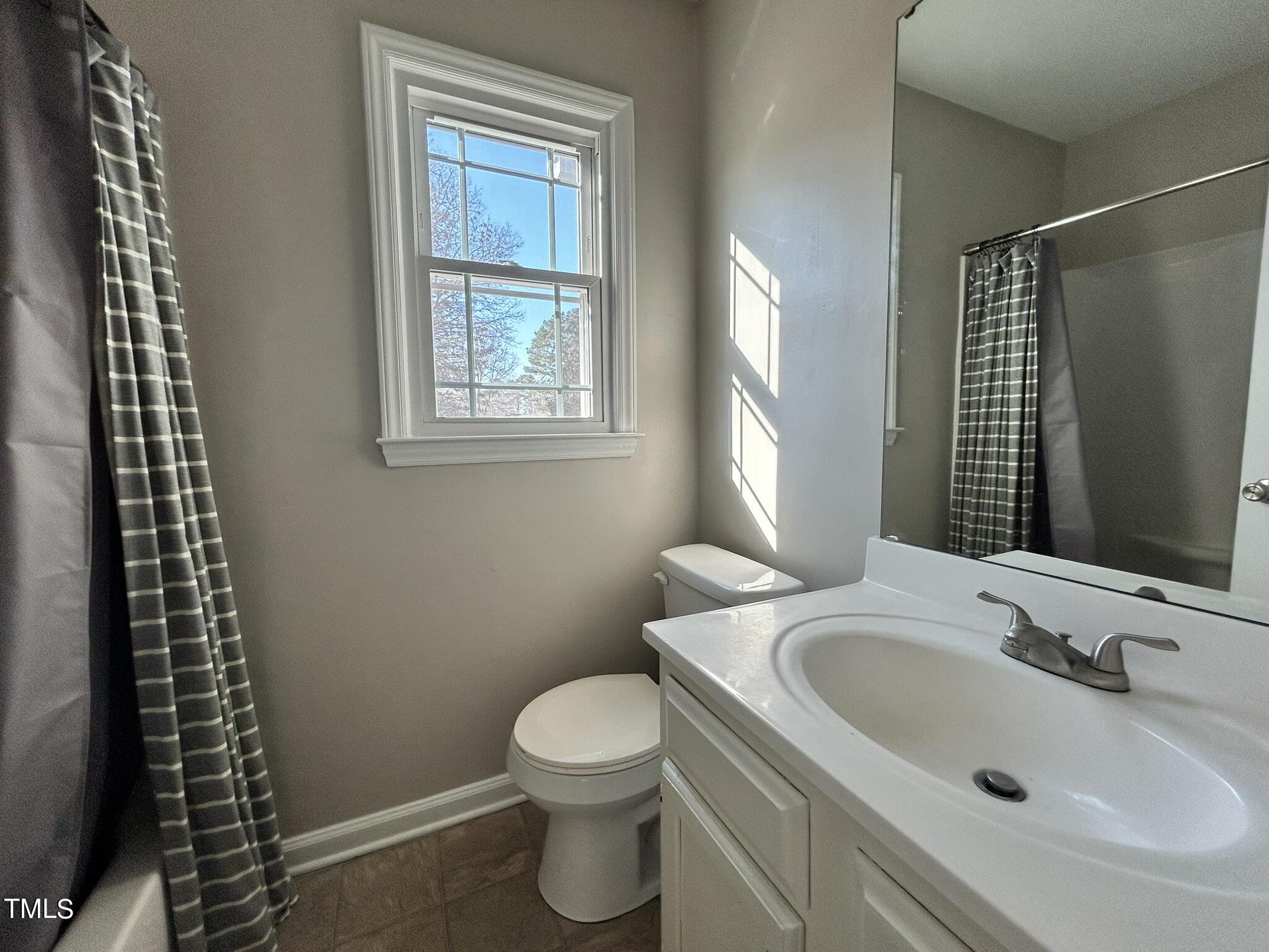 13535 Cleveland Road Garner, NC 27529 - Photo 10 of 18 a bathroom with a sink toilet and shower