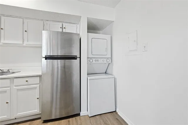a white refrigerator freezer and a stove sitting inside of a kitchen