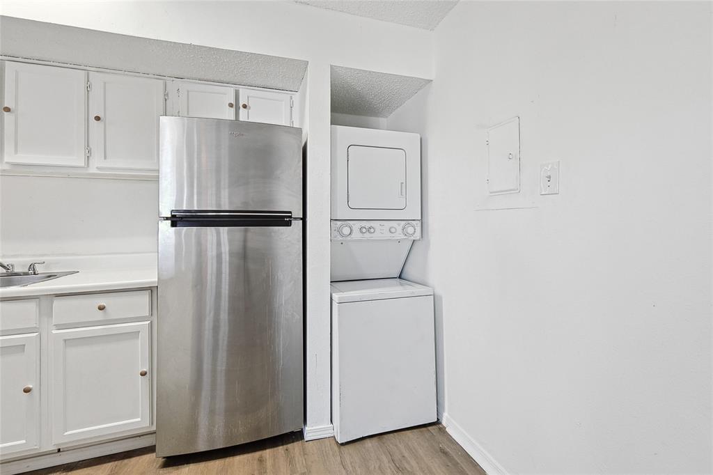 9839 Walnut Street, Unit 306 Dallas, TX 75243 - Photo 11 of 33 a white refrigerator freezer and a stove sitting inside of a kitchen