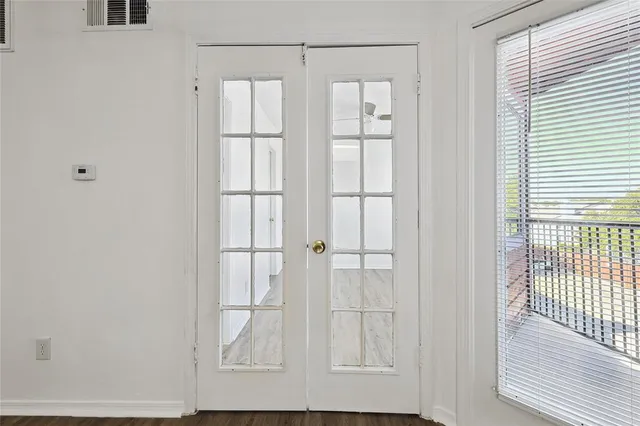 a view of bathroom with a glass door and a window