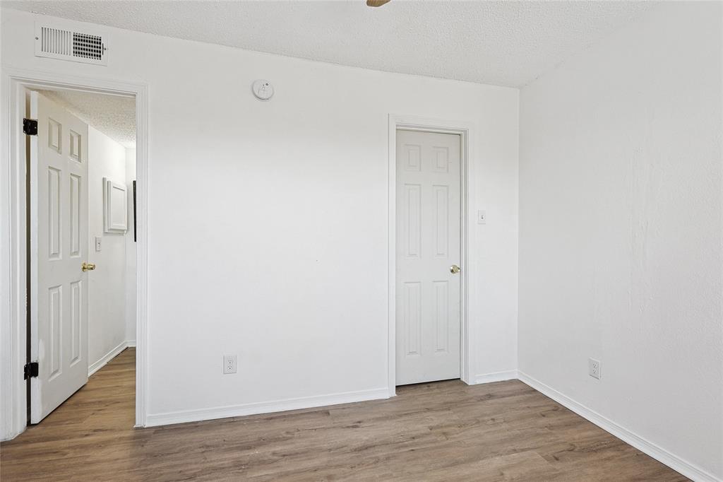 9839 Walnut Street, Unit 306 Dallas, TX 75243 - Photo 18 of 33 a view of an empty room with wooden floor