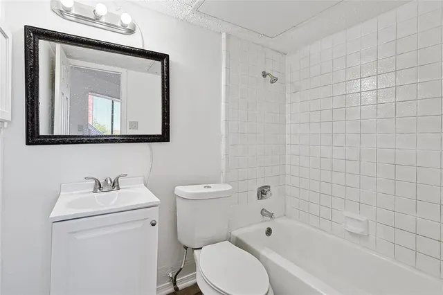 a bathroom with a toilet a sink and bathtub