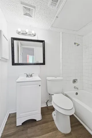 a bathroom with a toilet a sink and bathtub