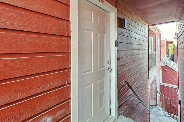 a view of a balcony with wooden floor and brick wall