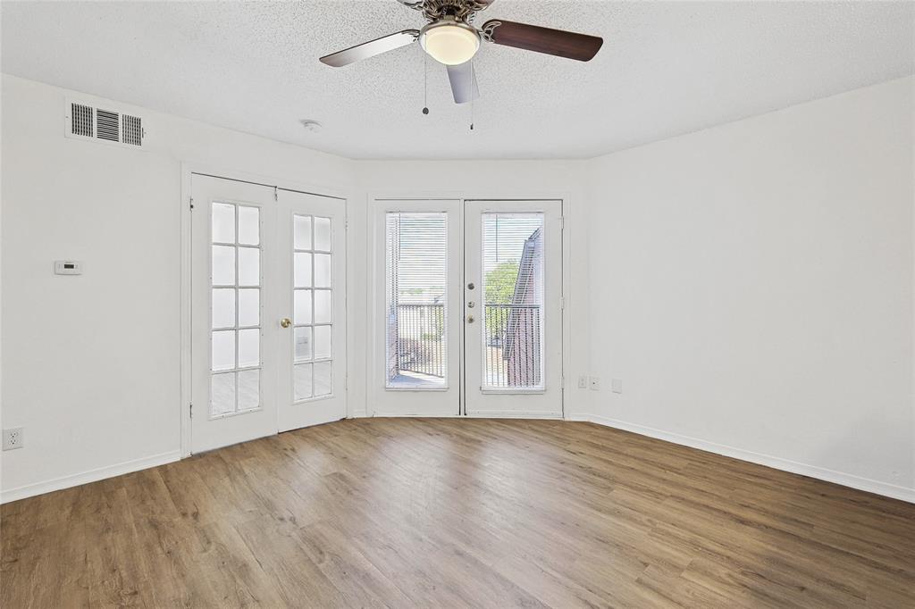 9839 Walnut Street, Unit 306 Dallas, TX 75243 - Photo 9 of 33 wooden floor in an empty room with a window