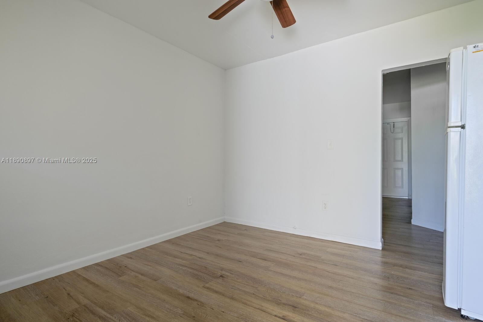 26701 Southwest 137th Avenue, Unit 4 Homestead, FL 33032 - Photo 3 of 7 an empty room with wooden floor and closet