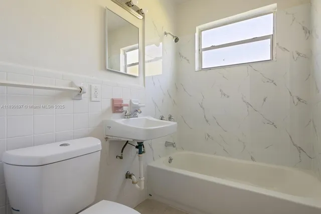 a bathroom with a sink toilet and bathtub