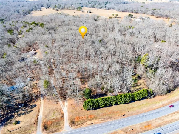 a view of a dry yard with wooden fence