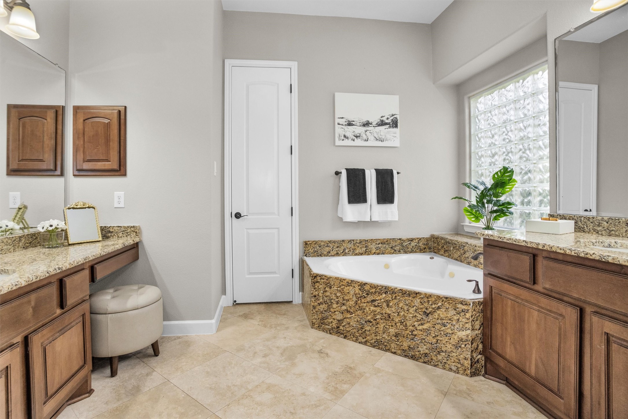 27910 Hansons Court Spring, TX 77386 - Photo 18 of 50 En suite bathroom offers corner jetted tub with granite surround, travertine flooring, dual vanities, including one seated, both with granite countertops, undermount porcelain sinks and Kentmore cabinetry.