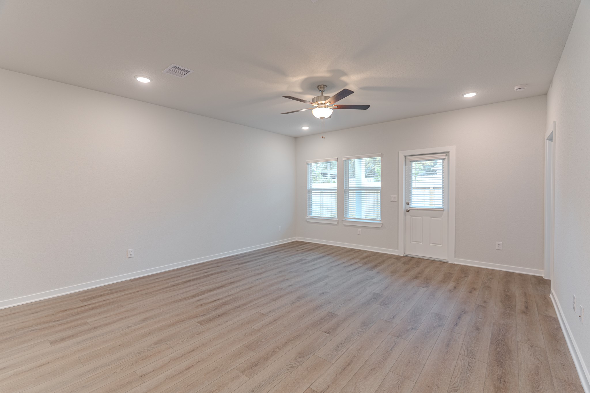8570 Blueberry Ash Street Magnolia, TX 77354 - Photo 11 of 30 a view of an empty room with a window and wooden floor