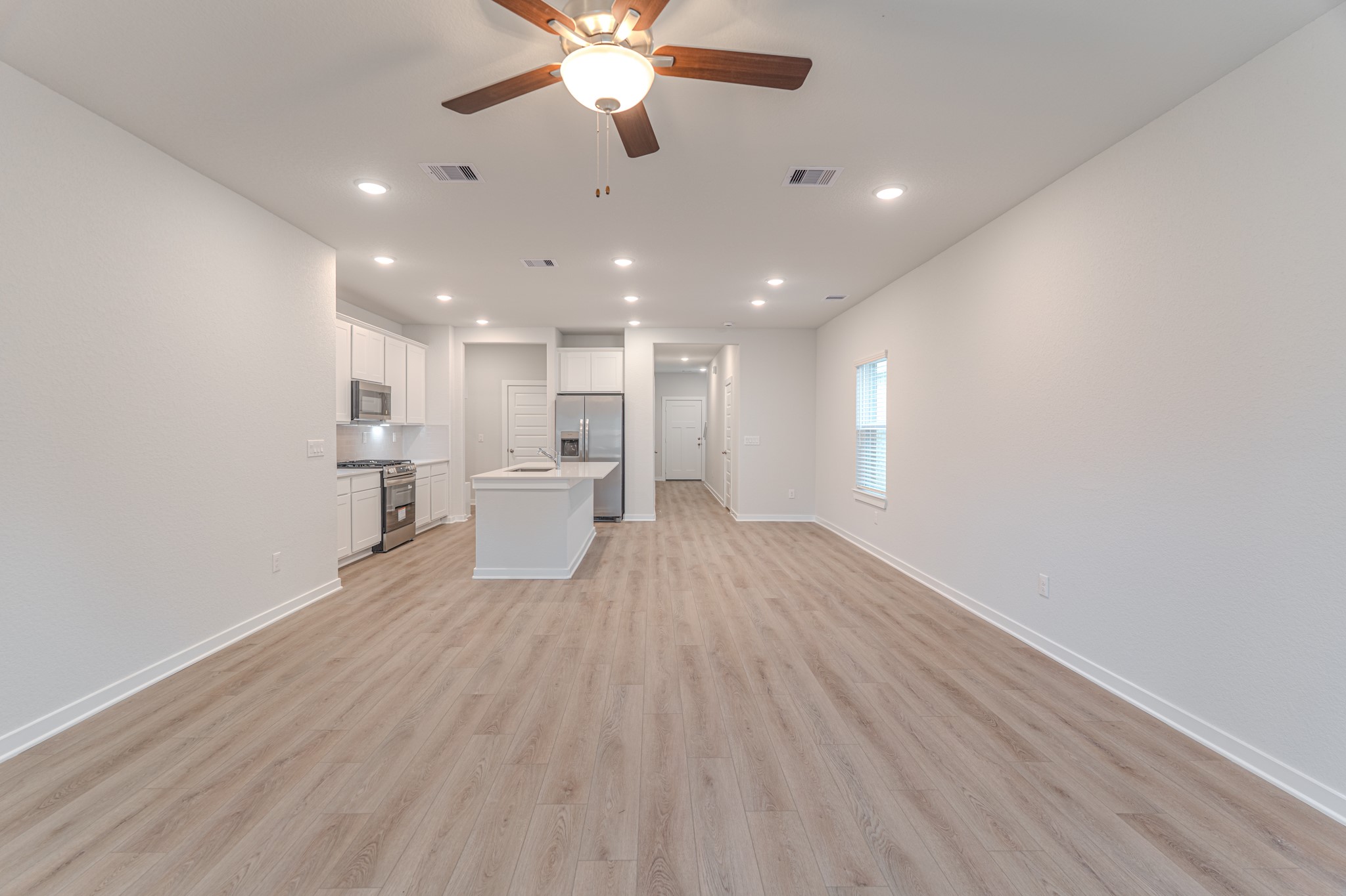 8570 Blueberry Ash Street Magnolia, TX 77354 - Photo 13 of 30 wooden floor in an empty room with a window
