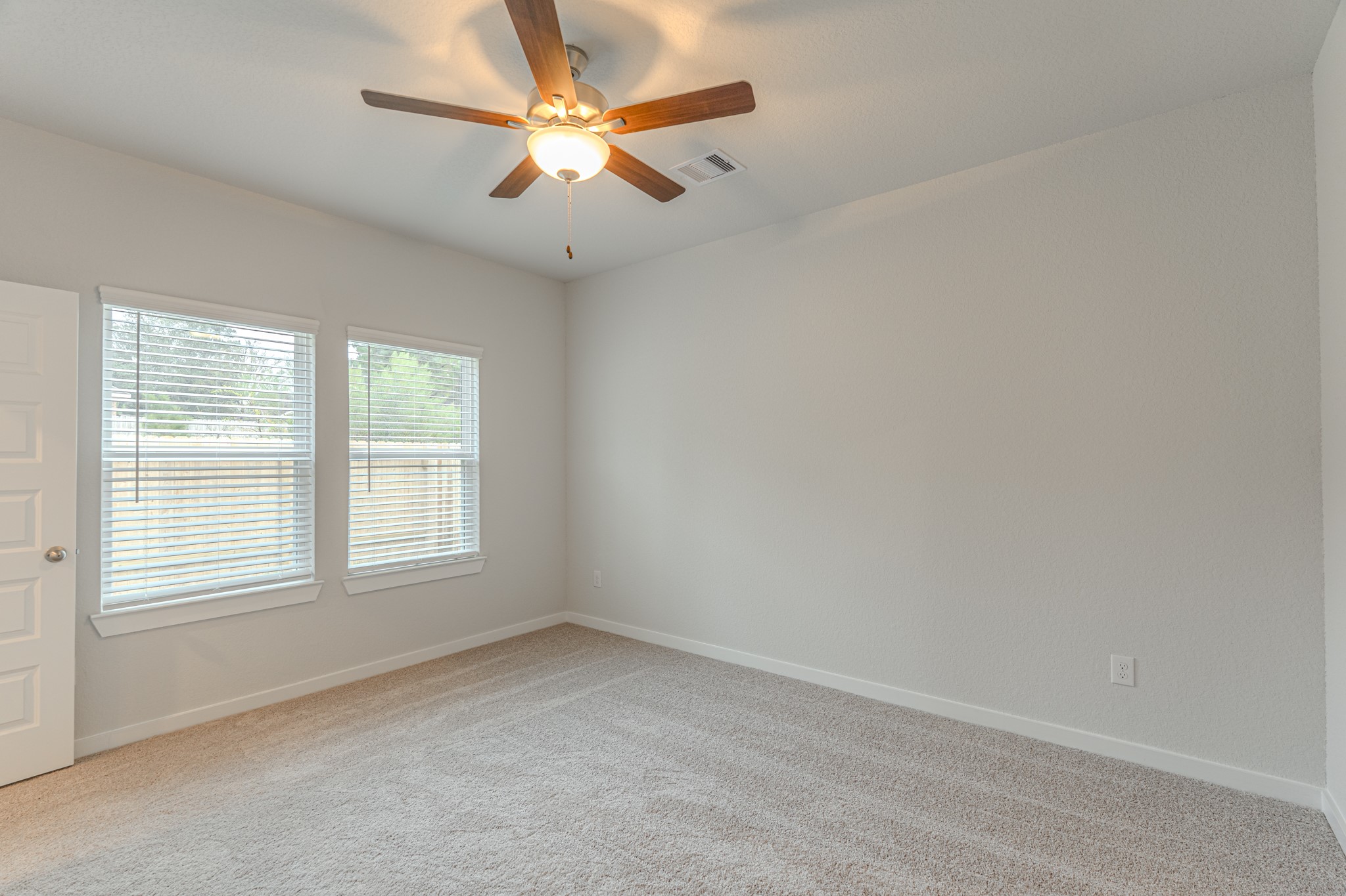 8570 Blueberry Ash Street Magnolia, TX 77354 - Photo 16 of 30 an empty room with a window and a fan
