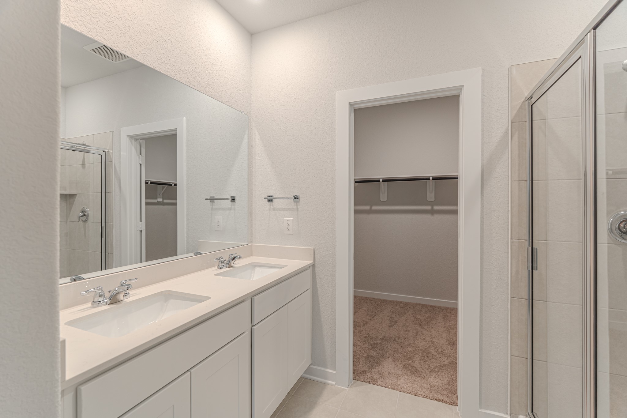 8570 Blueberry Ash Street Magnolia, TX 77354 - Photo 17 of 30 a bathroom with a double vanity sink and mirror