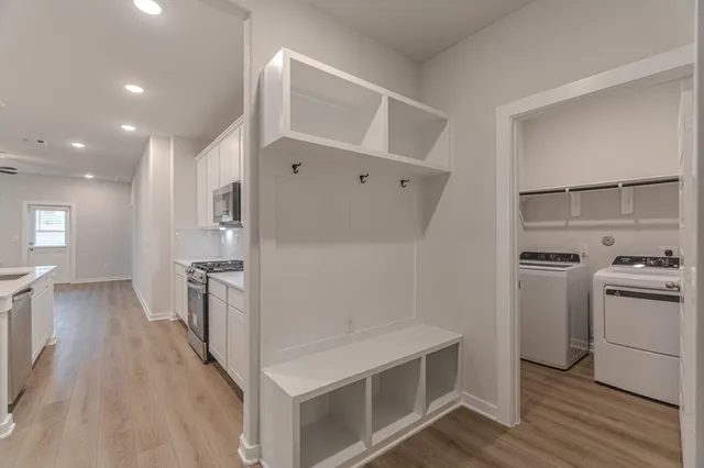 a kitchen with white cabinets and stainless steel appliances
