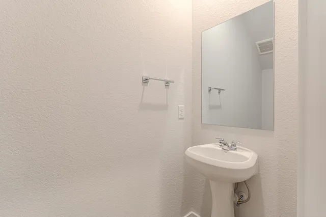 a bathroom with a sink and mirror