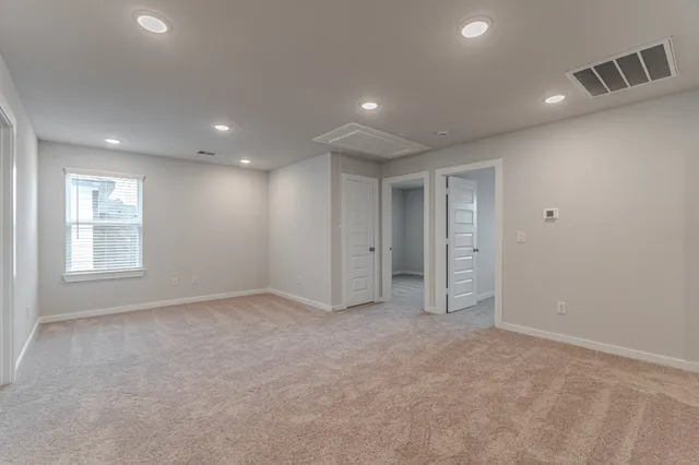 a view of an empty room with windows