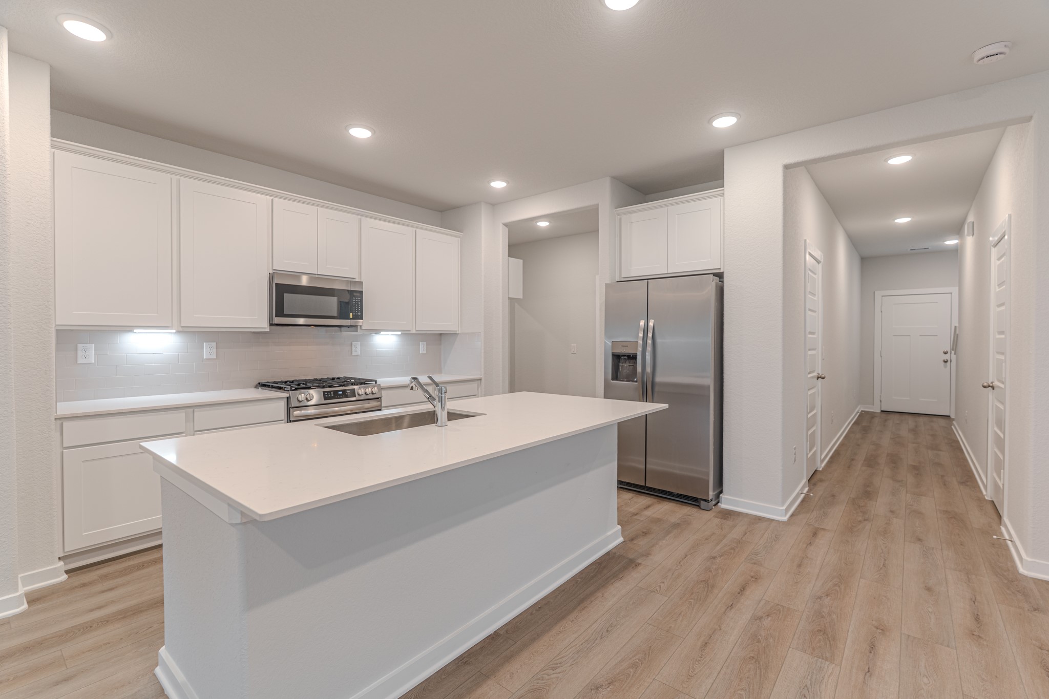 8570 Blueberry Ash Street Magnolia, TX 77354 - Photo 6 of 30 a kitchen with kitchen island a sink appliances and cabinets