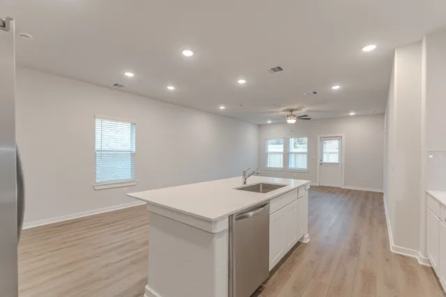 a kitchen with a sink and chandelier