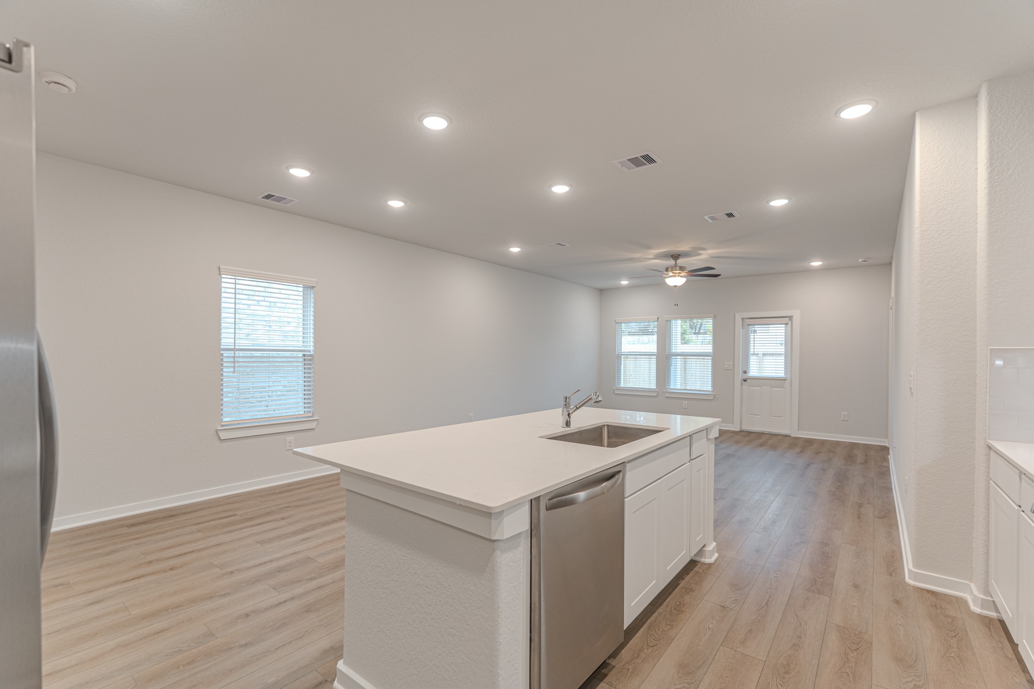 8570 Blueberry Ash Street Magnolia, TX 77354 - Photo 8 of 30 a kitchen with a sink and chandelier