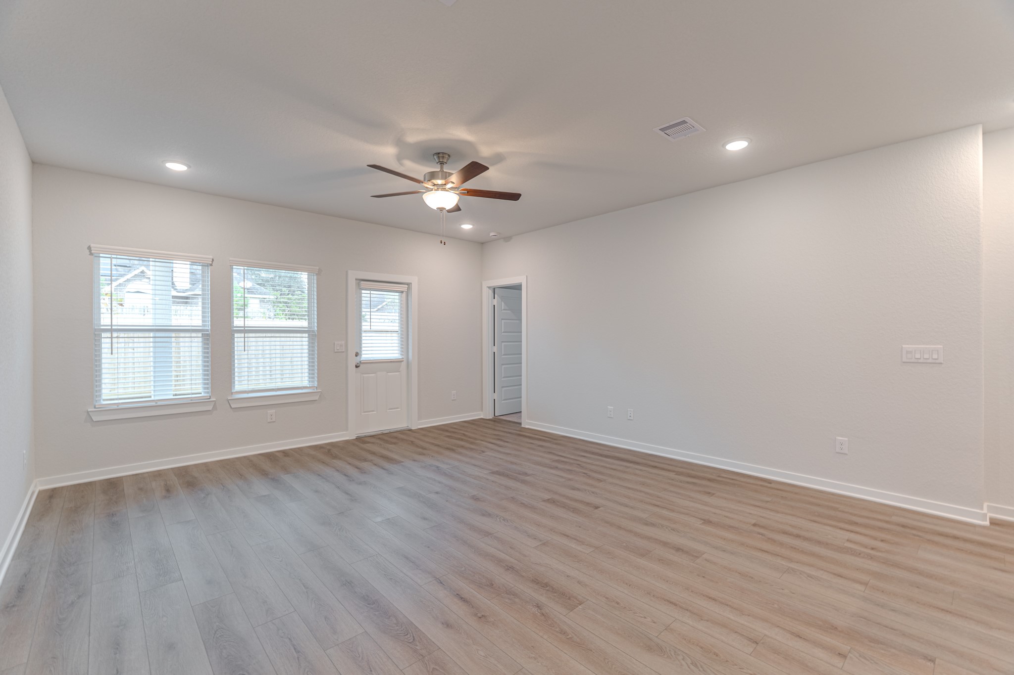 8570 Blueberry Ash Street Magnolia, TX 77354 - Photo 10 of 30 an empty room with wooden floor and windows