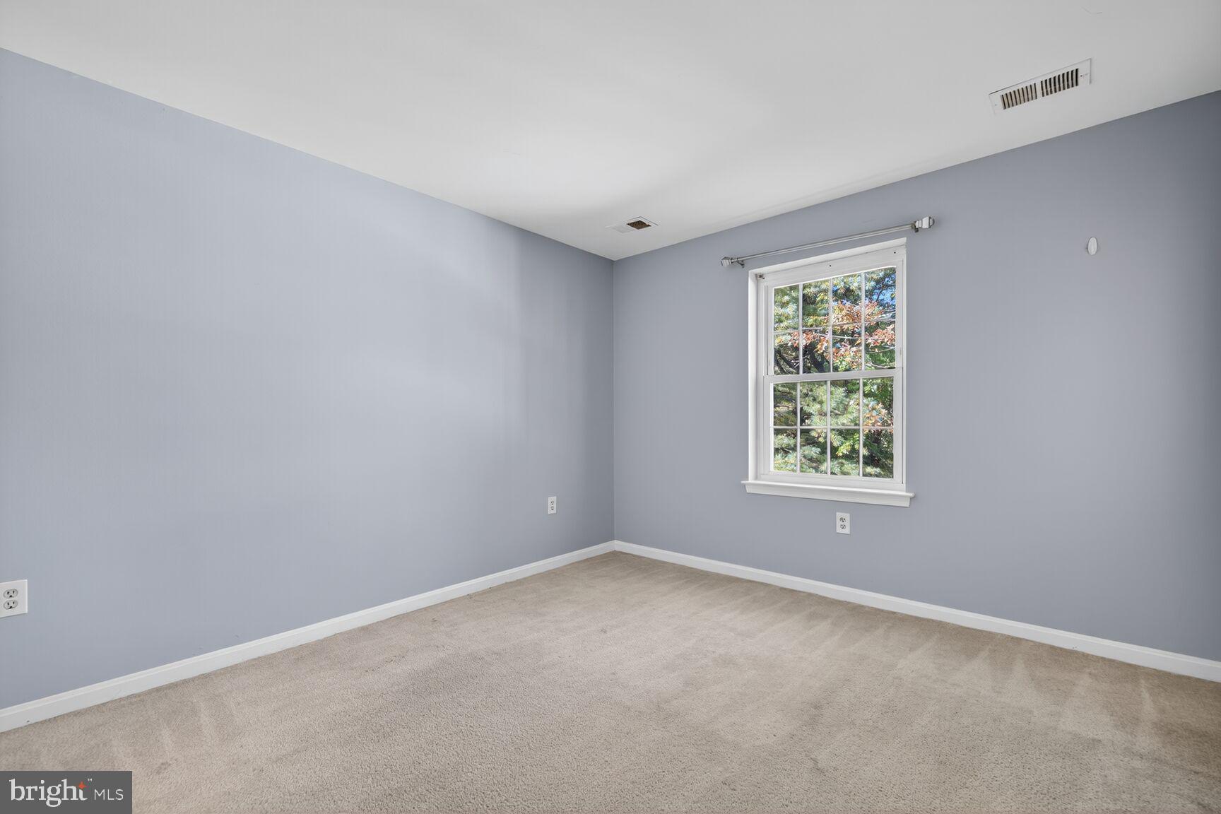 18318 Streamside Drive, Unit 302 Gaithersburg, MD 20879 - Photo 6 of 17 an empty room with windows
