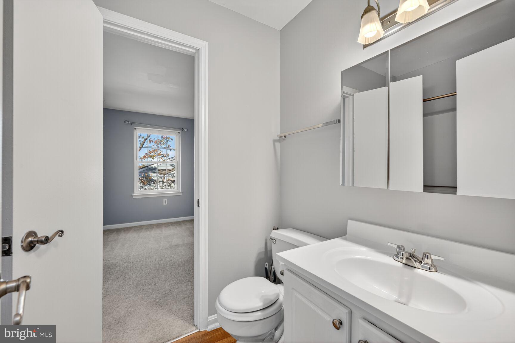 18318 Streamside Drive, Unit 302 Gaithersburg, MD 20879 - Photo 7 of 17 a bathroom with a sink a toilet and shower