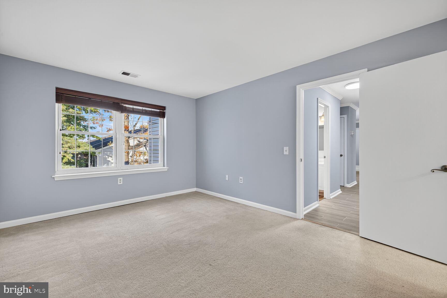 18318 Streamside Drive, Unit 302 Gaithersburg, MD 20879 - Photo 9 of 17 a view of an empty room with a window