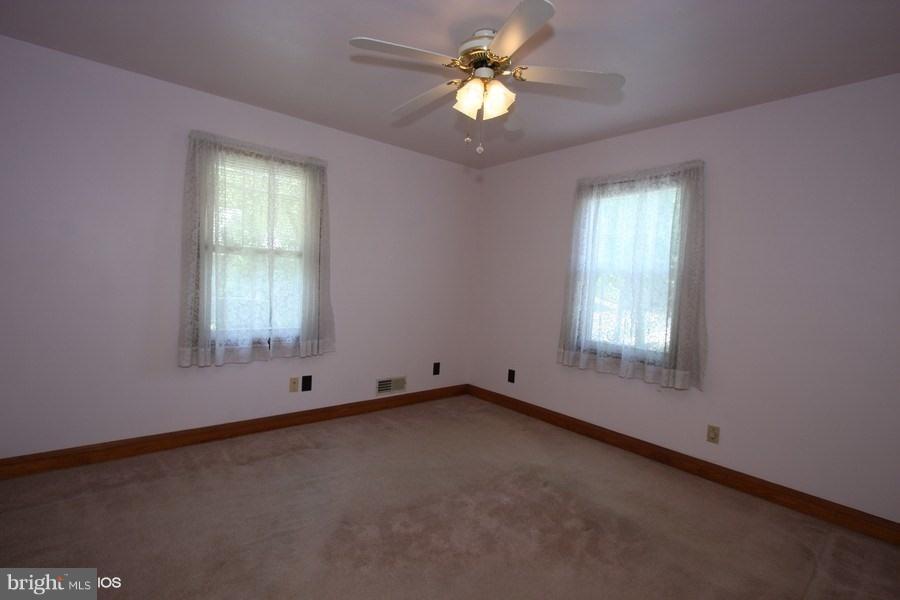 412 West Maple Road Linthicum Heights, MD 21090 - Photo 16 of 28 an empty room with windows and fan