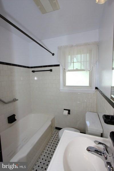 412 West Maple Road Linthicum Heights, MD 21090 - Photo 17 of 28 a bathroom with a tub and a shower