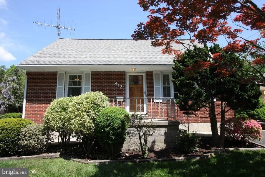 412 West Maple Road Linthicum Heights, MD 21090 - Photo 27 of 28 front view of a house with a garden
