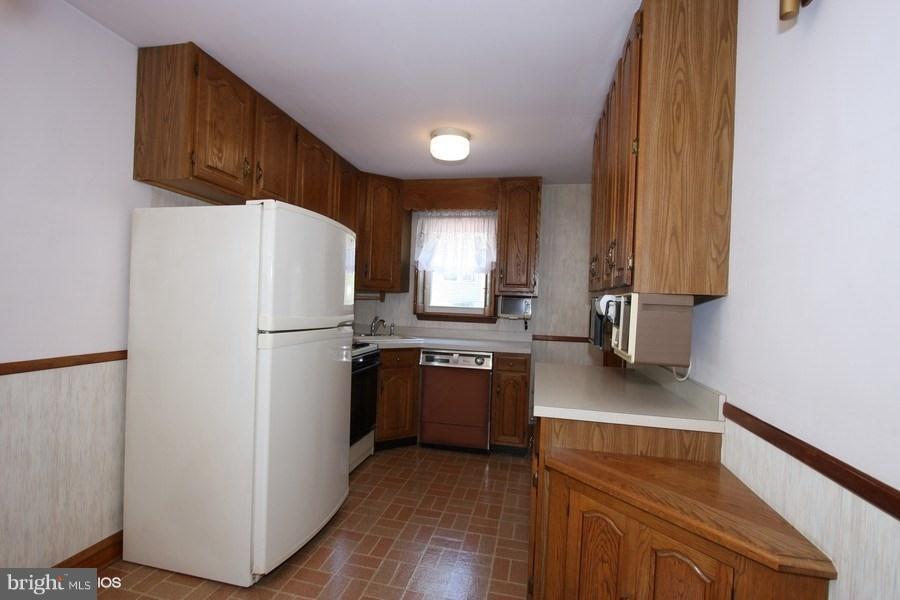 412 West Maple Road Linthicum Heights, MD 21090 - Photo 6 of 28 a kitchen with a refrigerator sink and stove