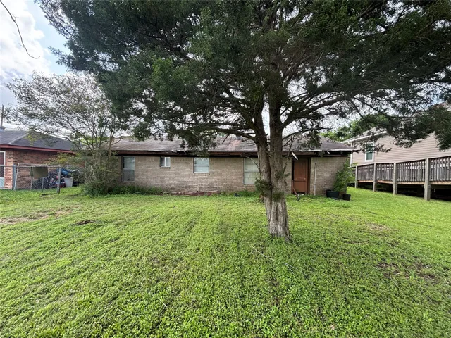 a view of a backyard with large trees