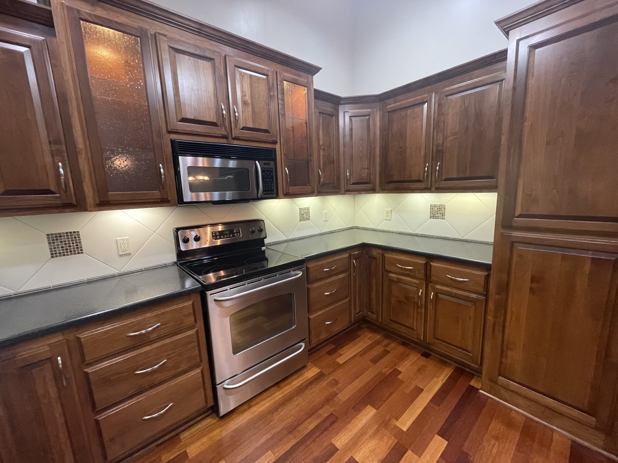 705 Blackpatch Drive, Unit 8 Springfield, TN 37172 - Photo 16 of 28 a kitchen with granite countertop wooden cabinets and a stove top oven