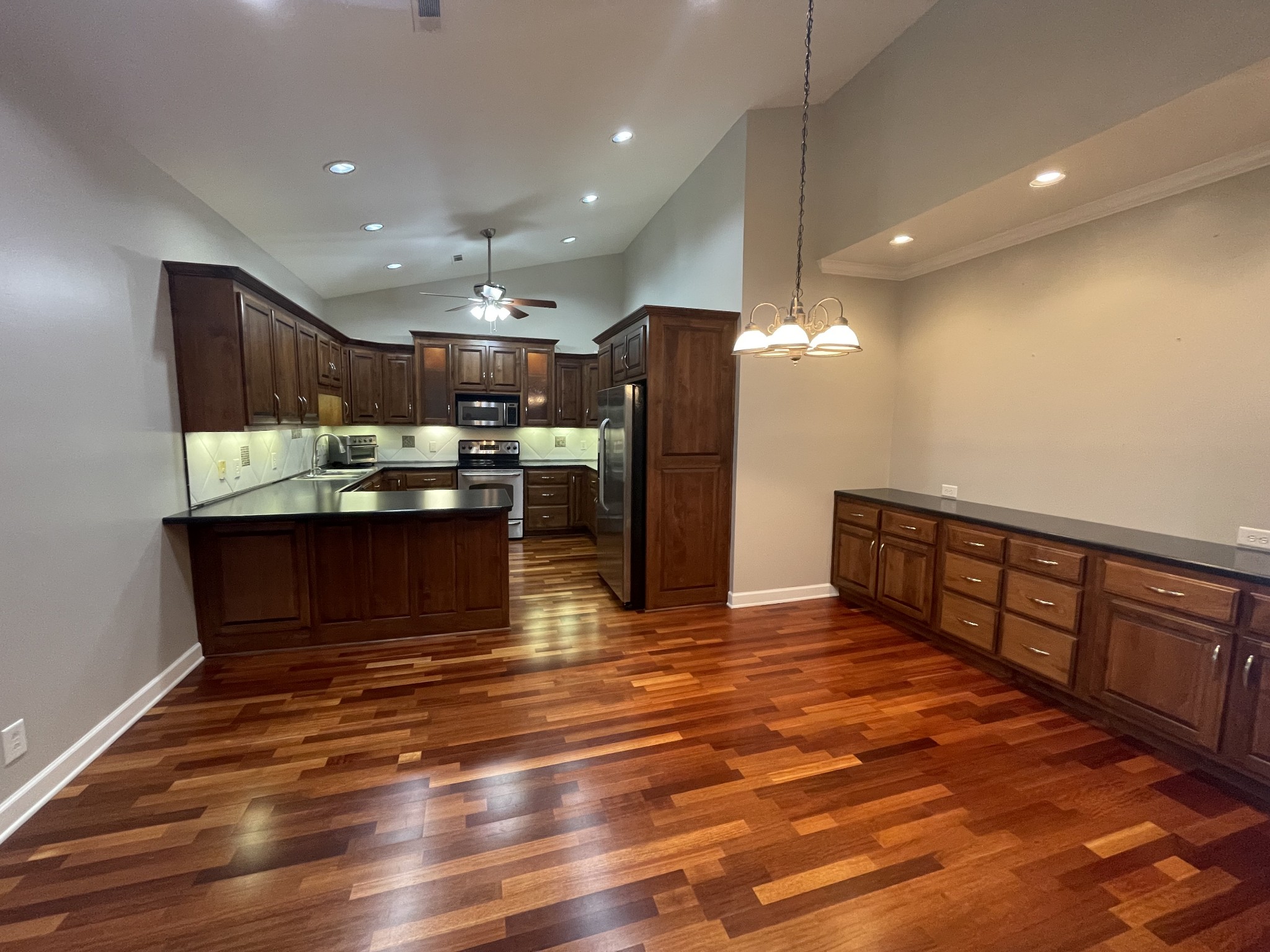 705 Blackpatch Drive, Unit 8 Springfield, TN 37172 - Photo 17 of 28 a kitchen with stainless steel appliances kitchen island granite countertop a refrigerator and a stove top oven