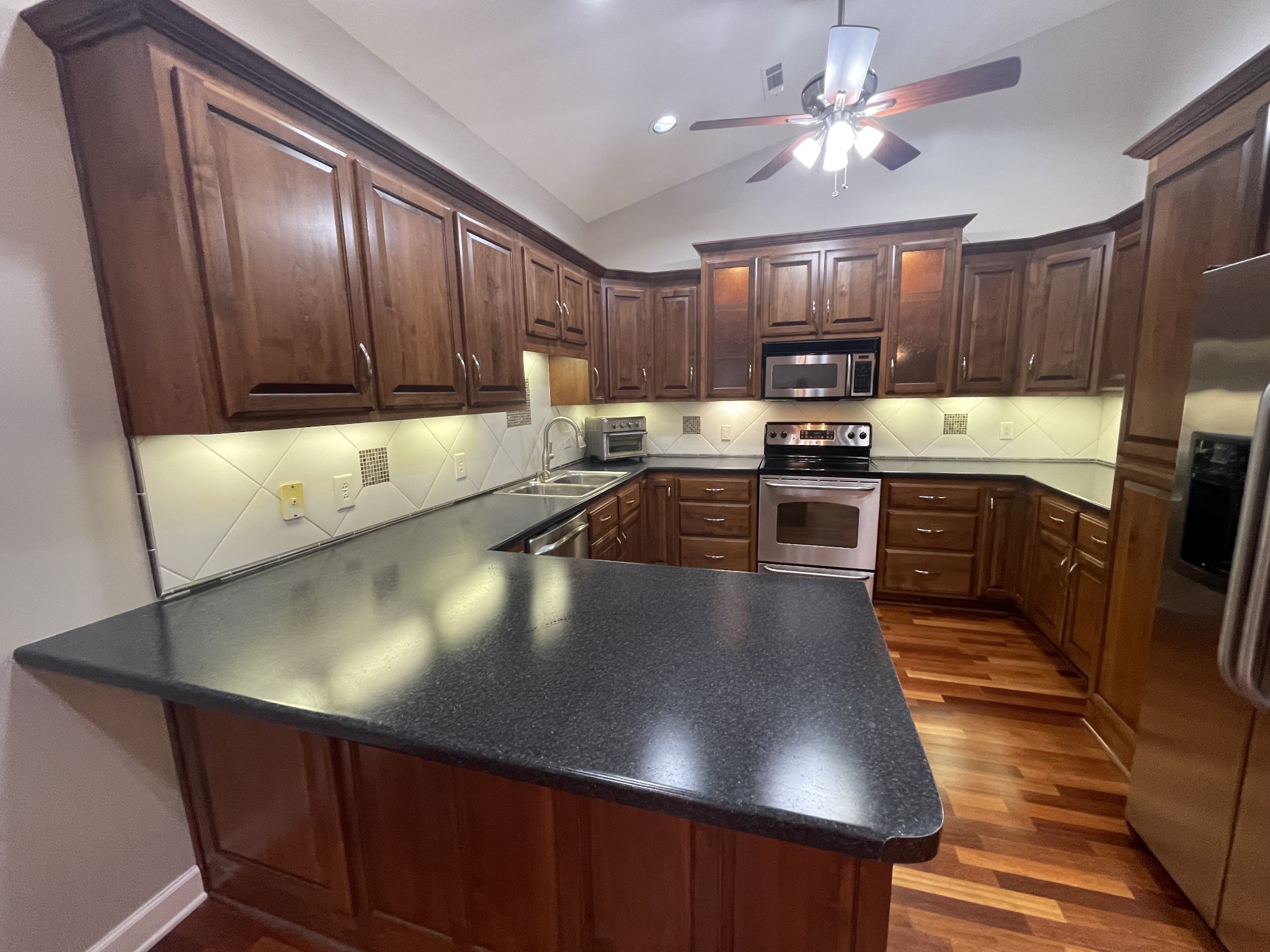 705 Blackpatch Drive, Unit 8 Springfield, TN 37172 - Photo 19 of 28 a kitchen with stainless steel appliances granite countertop a sink window and cabinets