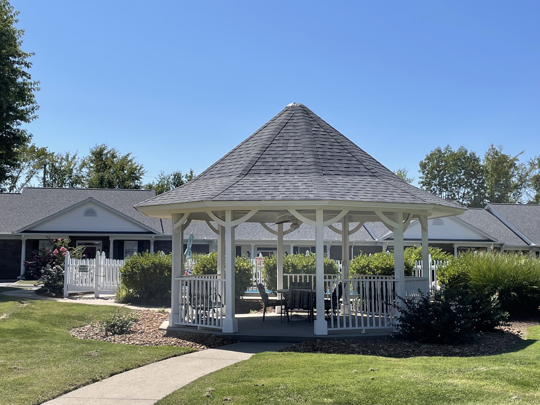 705 Blackpatch Drive, Unit 8 Springfield, TN 37172 - Photo 7 of 28 a patio with a table and chairs under an umbrella