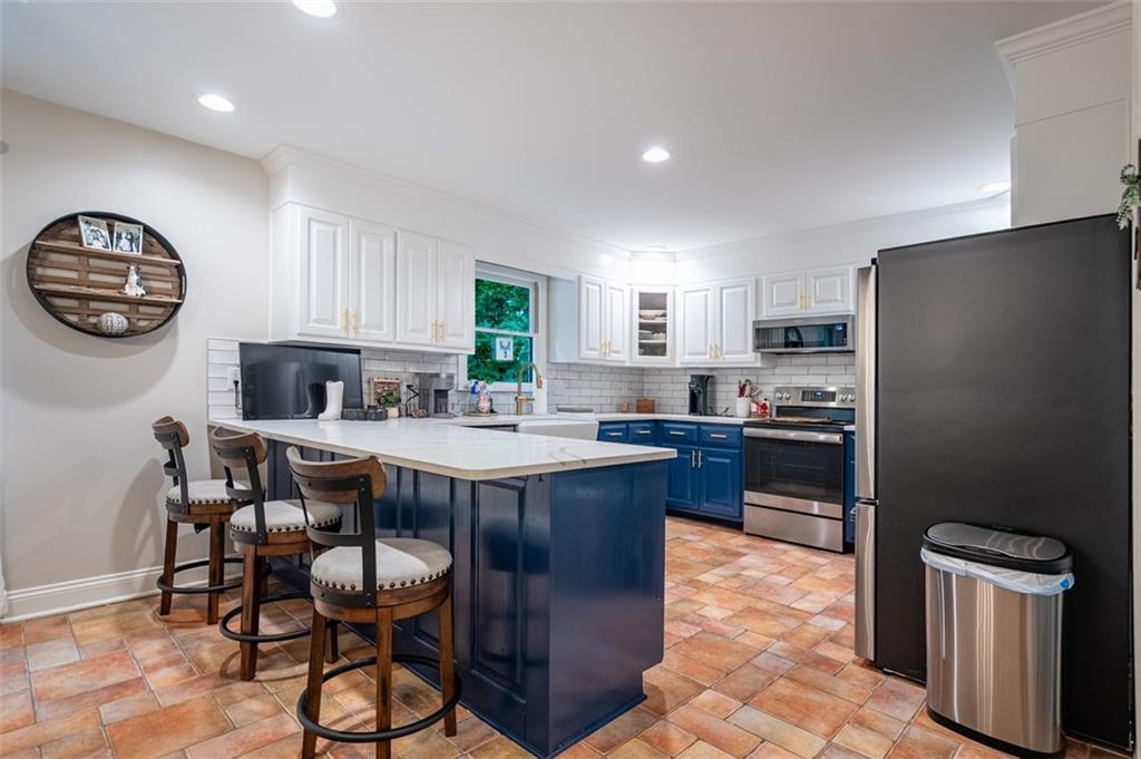 30 Westover Drive Southwest Rome, GA 30165 - Photo 11 of 51 a kitchen with a table chairs refrigerator and microwave